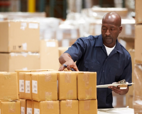 Discrete Picking warehouse worker looking at boxes
