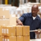Discrete Picking warehouse worker looking at boxes