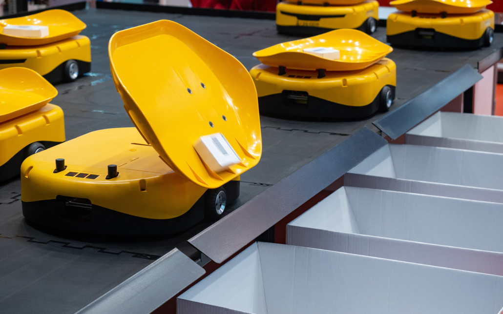 Several Yellow Sorting Robots on Warehouse Conveyor